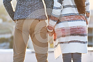 Young man and woman embrace and having fun outdoors