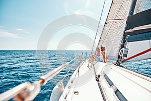 Young man and woman enjoying view on cruise ship deck