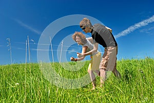 Young man and woman on green field