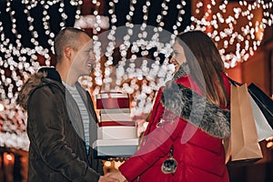 Young man and woman are laughing, walking and buying presents for their darlings and each other