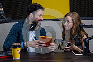 Young man and woman looking involved while searching something online