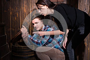 Young man and woman opened a barrel and trying to solve a conundrum to get out of the trap