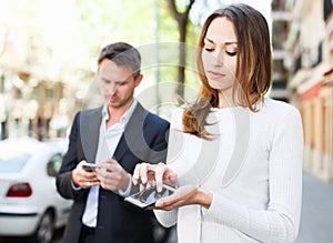 Young man and woman phubbing