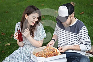 A young man and woman on a picnic on a date together.