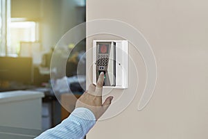 Young man or woman push down the electronic control machine to access the door