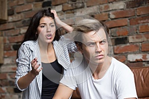 Young man and woman quarreling at home