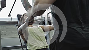 Young man and woman relaxing and exercising at the gym.