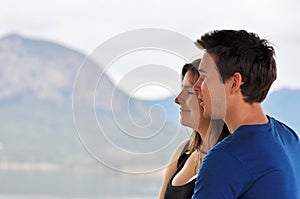 Young man & woman smiling on holiday