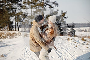 Young man and woman spending time together at winter day