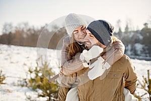 Young man and woman spending time together at winter day