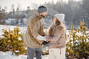 Young man and woman spending time together at winter day