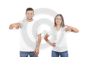 Young man and woman in stylish t-shirts on white background photo