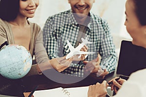 Young Man and Woman in Travel Agency with Manager.