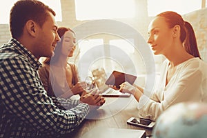 Young Man and Woman in Travel Agency with Manager.