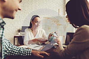 Young Man and Woman in Travel Agency with Manager.