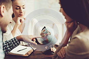 Young Man and Woman in Travel Agency with Manager.