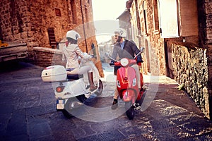 Young man and woman on Vespa Scooter. Bikers couple