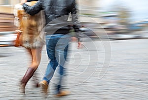 Young man and woman walking down the street