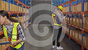 Young man and woman worker check stock and inspection with document on clipboard in the warehouse.
