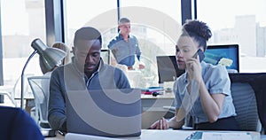 Young man and woman working on computer