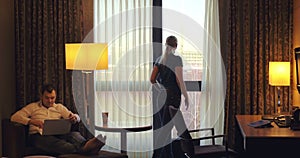 Young man and woman working in hotel room