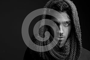 Young man with wool scarf covering head