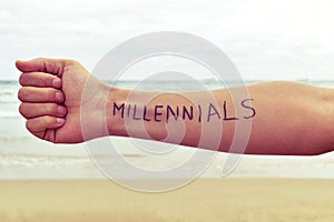 Young man with the word millennials written in his arm