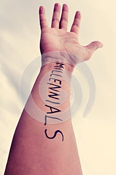 Young man with the word millennials written in his arm, filtered