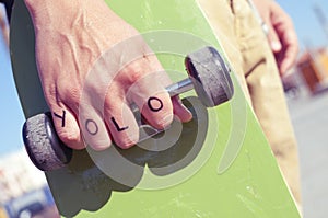 Young man with the word yolo, for you only live once, tattooed photo