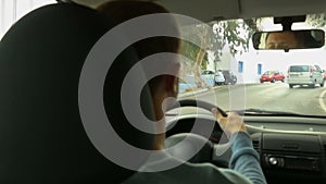 Young man working as taxi driver and carrying people from airport to city