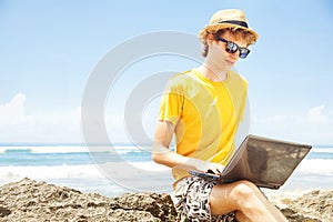 Young man working on a beach