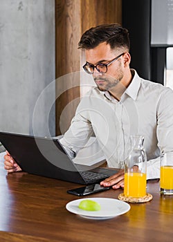 Young man working on a computer at home. Entrepreneur a freelance worker working from home