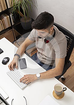 Young man working on computer in home office.education.business.e-commerce