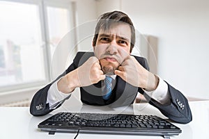 Young man is working with computer and looking at you