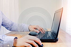 Young man working on computer notebook at table indoors, closeup. Banner design.Business technology lifestyle.strategy planning