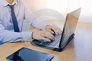 Young man working on computer notebook at table indoors, closeup. Banner design.Business technology lifestyle.strategy planning