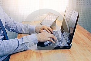 Young man working on computer notebook at table indoors, closeup. Banner design.Business technology lifestyle.strategy planning