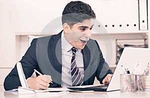 Young man is working at a computer