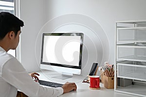 Young man working with computer pc at home office.