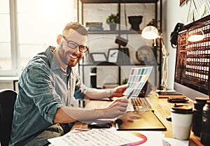 Young man working at computer at workplace