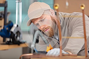young man working on copper pipes