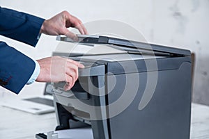 Young man working copy machine