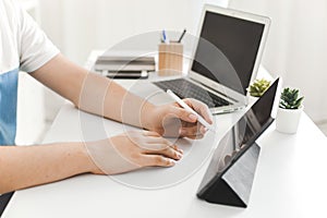 YOUNG MAN WORKING ON DESK AT HOME OFFICE BUSINESS photo