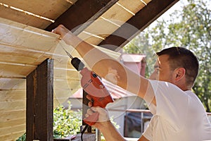 Young man working with drill