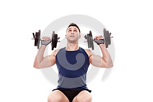 Young man working with dumbbells photo