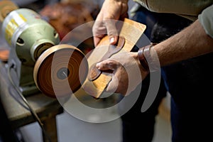 young man working on Electric Leather Burnisher Machine photo