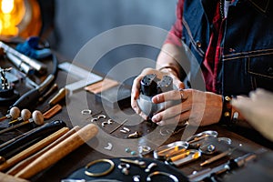 Young man working with a graving ball at workplace