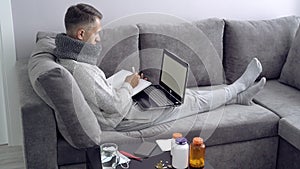 Young man working from home during illness. Online education.