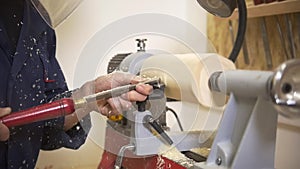 Young man working with joinery using hand tool in carpentry workshop