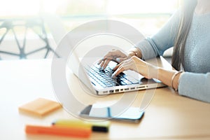 Young man working with laptop, man hands on notebook computer, business person at workplace